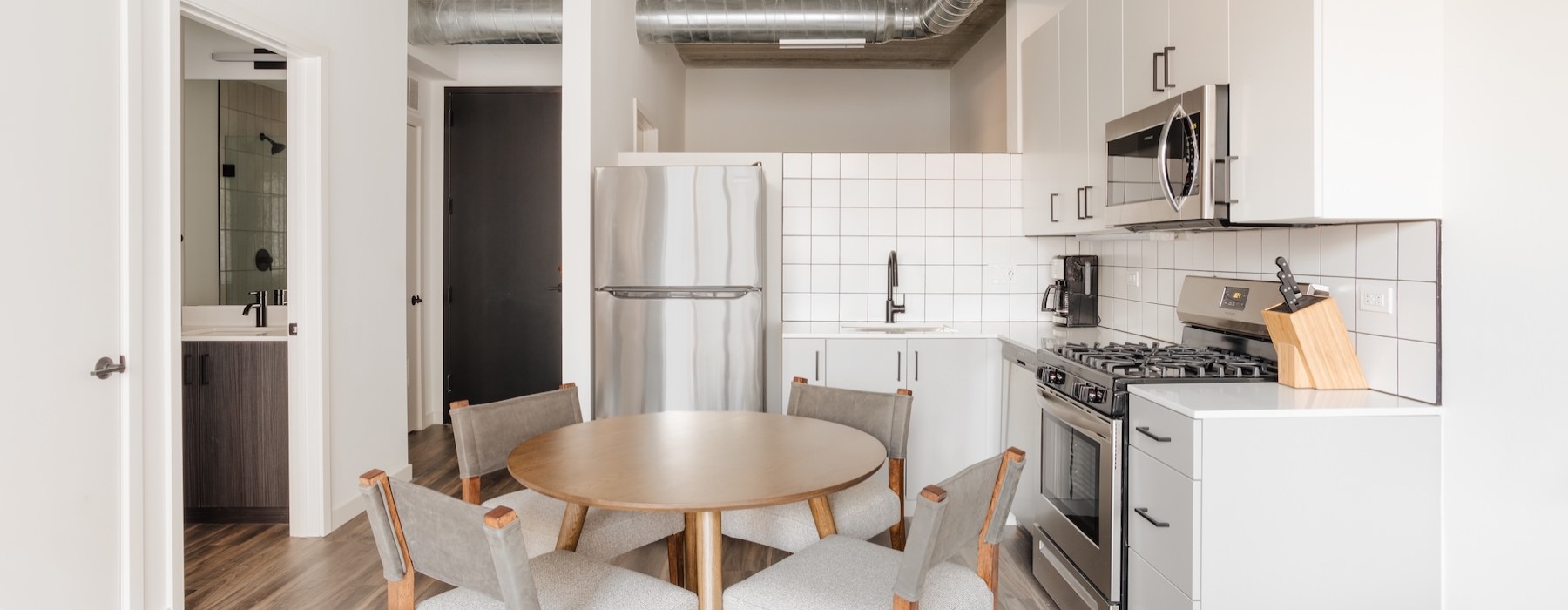 a kitchen with a table and chairs