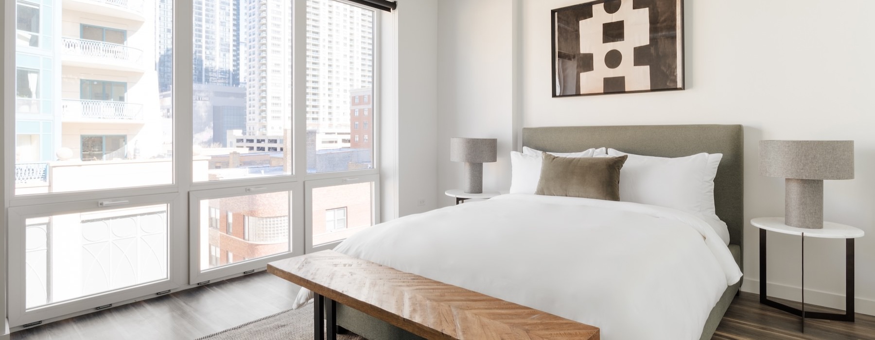 a bedroom with a bed and a large window