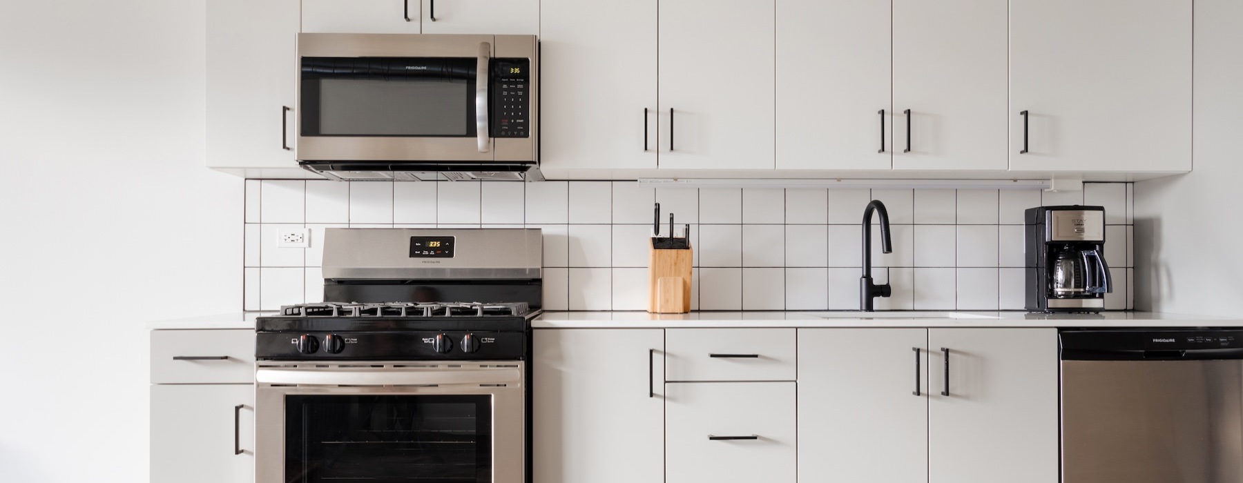 a kitchen with white cabinets