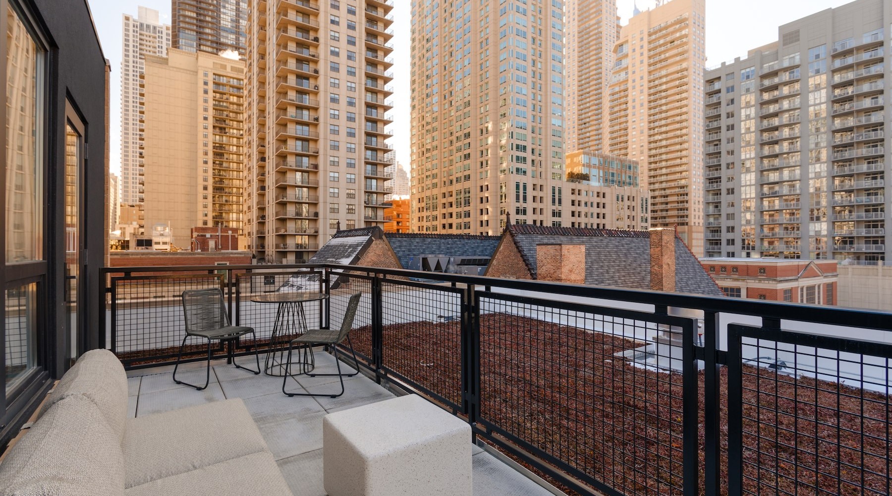 a patio with a couch and a view of a city