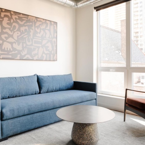 a living room with a blue couch and a coffee table