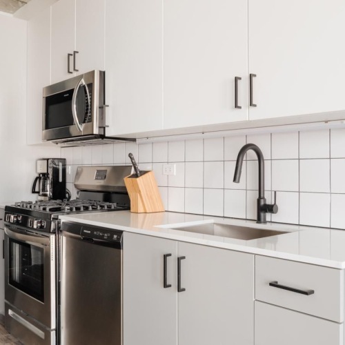 a kitchen with white cabinets